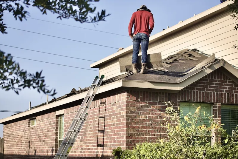 Professional roofer working on a residential roof in North Franklin
